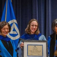 Provost Mili and President Mantella smile for picture with woman holding certificate